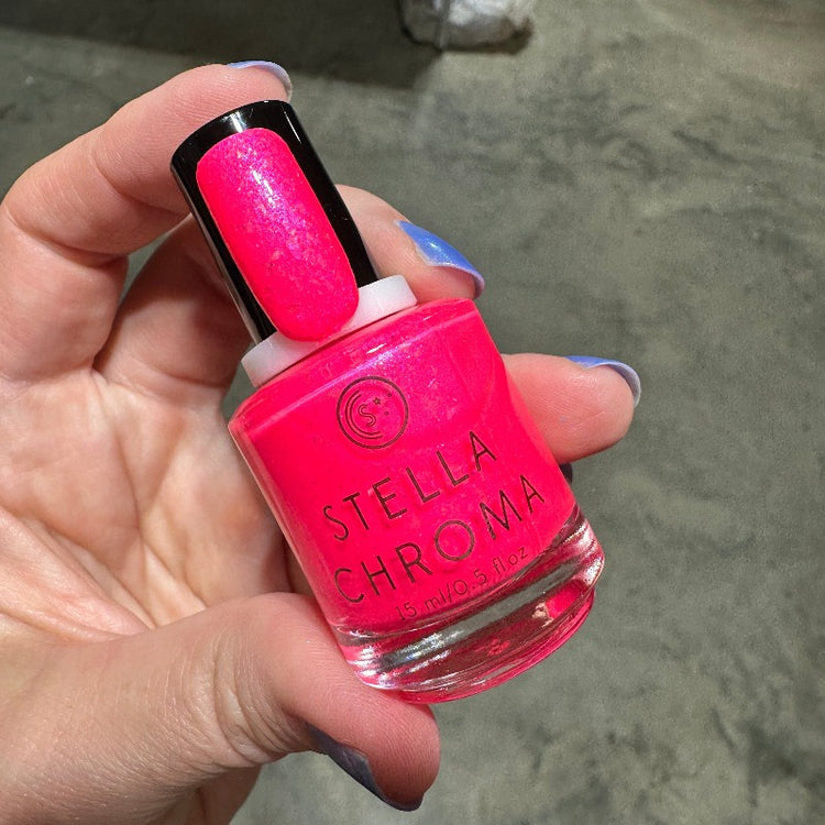 Neon Pink nail polish with blue/green shifting shimmer and yellow/red/orange flakies